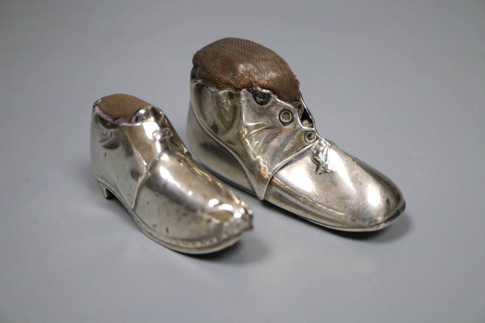 Two early 20th century novelty silver mounted pin cushions, modelled as shoes,